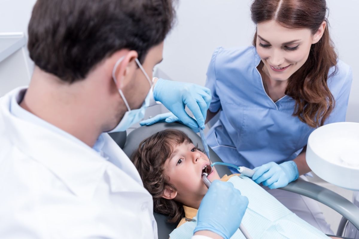 Pediatric Dentist in Bentonville examining a child's teeth