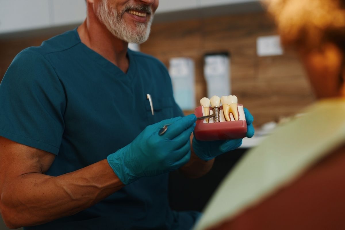 Dental Implants Model Bering Shown by Dentist in Bentonville, AR