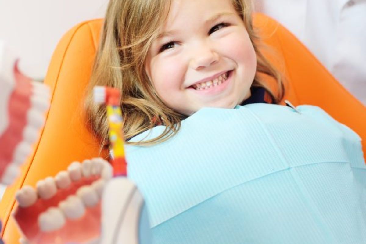 a child smiling after dental flossing at dentistry in Bentonville, AR